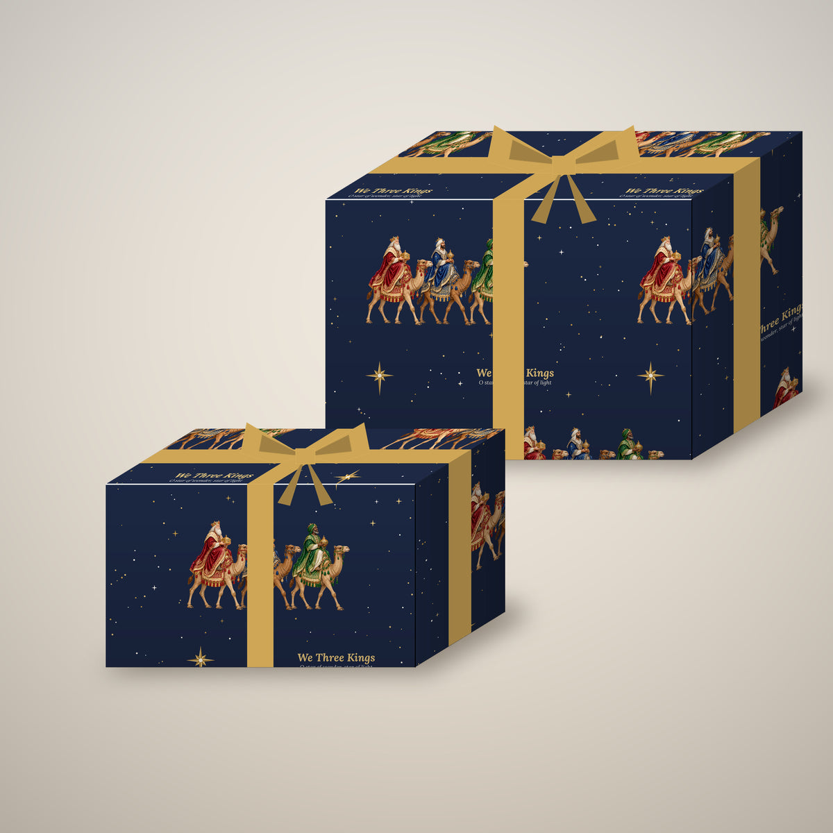 We Three Kings Christmas wrapping paper on two wrapped gift boxes with a bow