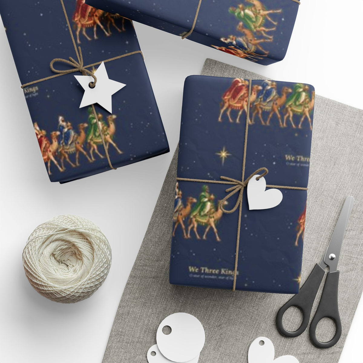 We Three Kings Christmas wrapping paper in navy, the Magi on camels with gold stars
